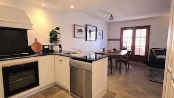 Deluxe Apartment, Courtyard View | Private kitchen | Coffee/tea maker, electric kettle, dining tables