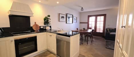 Deluxe Apartment, Courtyard View | Private kitchen | Coffee/tea maker, electric kettle, dining tables