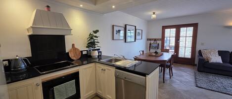 Deluxe Apartment, Courtyard View | Private kitchen | Coffee/tea maker, electric kettle, dining tables