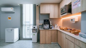 Een moderne keuken met inbouwapparatuur, houten kastjes en een aanrecht met manden.