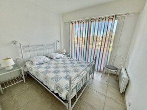 Cozy retreat with a single bed, bedside table, and comfortable chair.