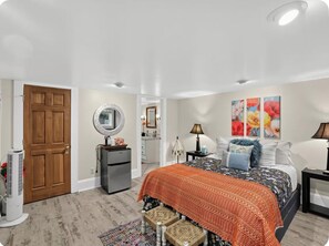 A bedroom with a bed, a dresser, a mirror, a nightstand, and a door. - Calm and Private Room in NE Portland (Portland)