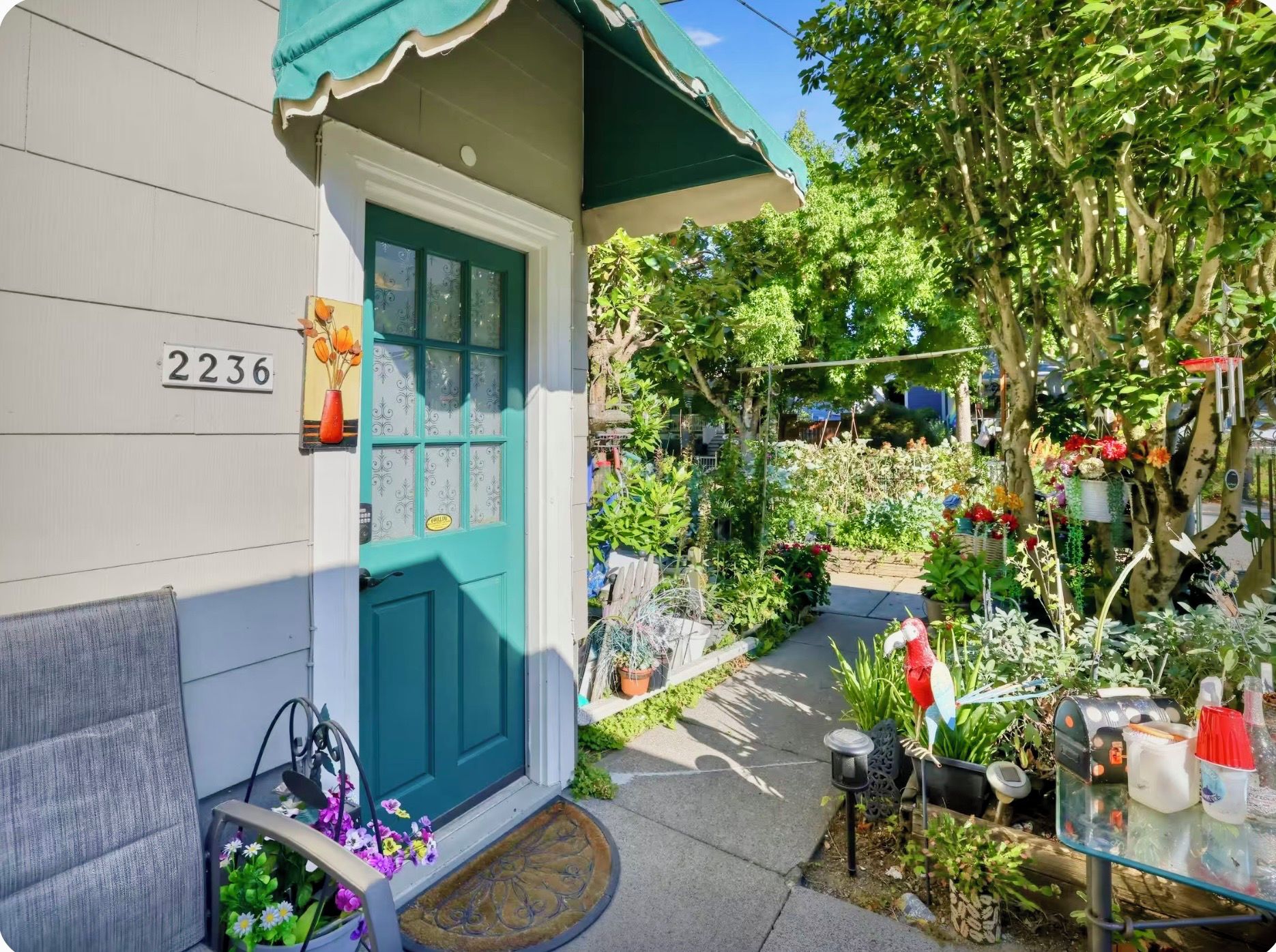 A house with a teal door and a number 2236 on the wall.