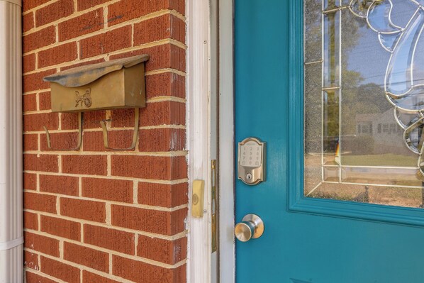 A blue door with a glass panel, a mailbox, and a doorbell. - Boat Parking & Shore Power, Dog-Friendly Duplex, Fenced Yard Near Pickwick Lake (Sheffield)