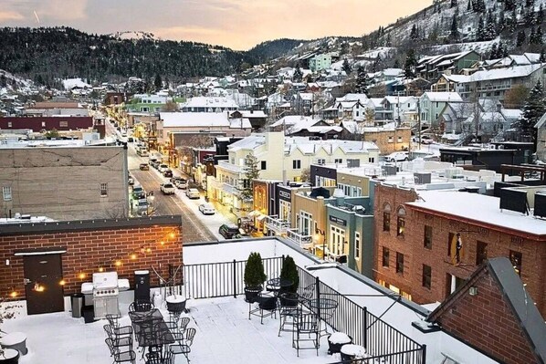 A snowy town with a view of buildings and a street.