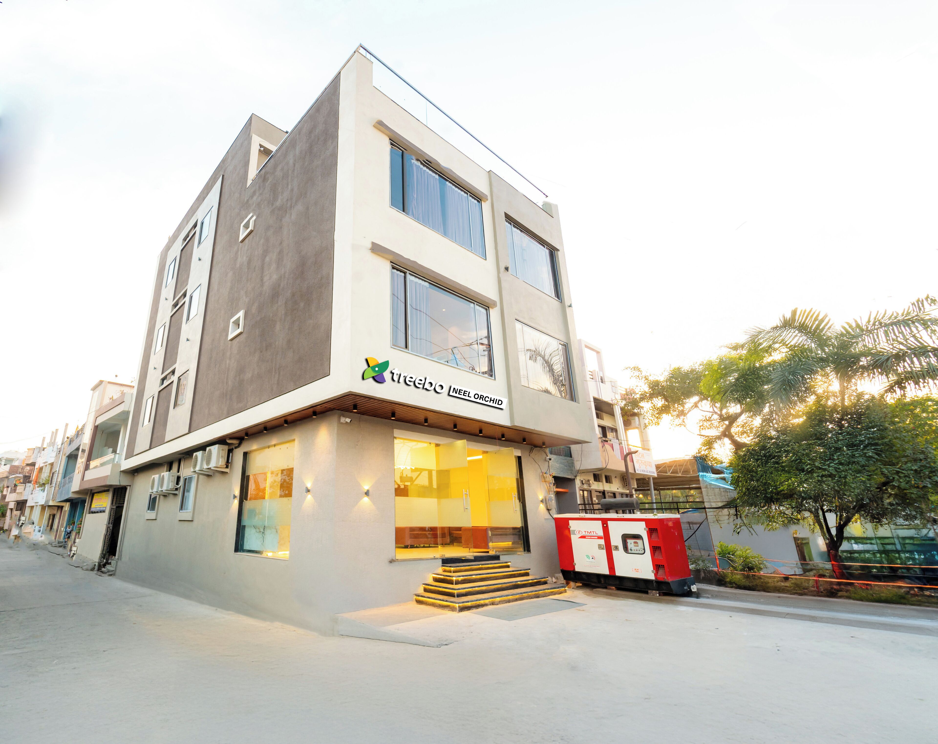 A modern building with a sign reading "treebo NEEL ORCHID".