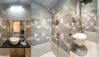 A bathroom with a sink, mirror, and shower.