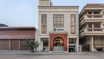A hotel named 'Hotel Divine Stay' with a restaurant, a banquet, and a Blinkk Luxury Dining.