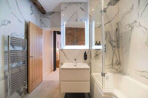Shower, hair dryer, towels, shampoo