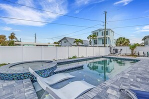 A swimming pool with a mosaic tile design, a hot tub, and a patio area. - Private Pool & Spa Retreat! Walk to the Beach | Beautifully Remodeled 1st Floor Mid-Island Apartment (Fort Myers Beach)