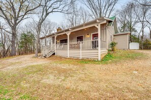 A wooden cabin with a porch, a staircase, and a small attached shed. - 5 Mi to Beaver Lake: Family Cabin w/ Game Room (Eureka Springs)