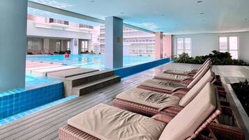 A poolside area with lounge chairs and a view of the pool.