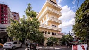 A multi-story building with balconies, surrounded by trees and other buildings. - Amara Palace (Phnom Penh)