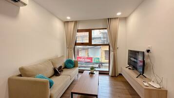 Standard Apartment, City View | Living area | 52-cm flat-screen TV with satellite channels