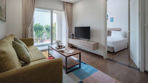 Een moderne hotelkamer met een bank, televisie en een bed.