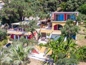 A multi-story building with balconies, a red door, and a blue window. - Studio Apartment 'With Sea View 1' with Sea View, Wi-Fi and Air Conditioning (Corfu)