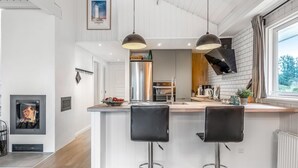 A modern kitchen with a central island, stainless steel appliances, and pendant lighting. - "Caya" - 750m from the sea by Interhome (Løkken)