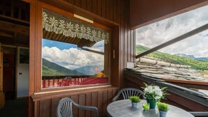 A wooden room with a window overlooking a mountainous landscape. - Alpine mezzanine studio, sleeps 4, pets allowed, optional parking (Valmorel)