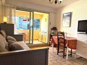 Enjoy a compact living space with a balcony offering a view of the surrounding building.