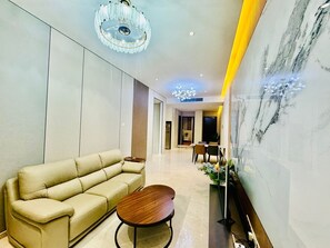 Family Apartment, Balcony, City View | Living area | 52-inch Smart TV with digital channels