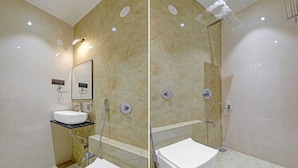 A modern bathroom with a white sink, a mirror, a shower, and a toilet. - HOTEL RATNA VILAS PALACE (Rajkot)