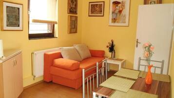 Apartment (One Bedroom Apartment) | Living room | 32-inch flat-screen TV with satellite channels