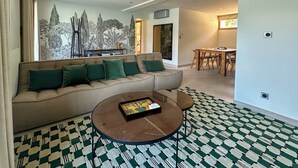 A modern living room with a sofa, a coffee table, and a patterned rug. - APARTMENT with private terrace & lake view / 200 meters from lake & bike path (Sévrier)
