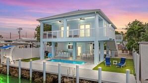 A two-story waterfront house with a pool, outdoor seating, and a balcony. - Azul Paradise ~ Waterfront ~ Games ~ Pool ~ Dock (Marathon)