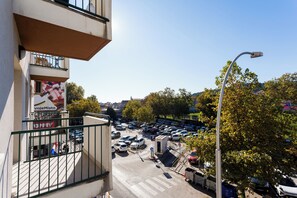 A parking lot with multiple cars and a small building with a sign. - Shine of Life Luxury Rooms (Split)
