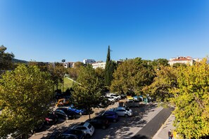A parking lot with multiple cars and a few pedestrians. - Shine of Life Luxury Rooms (Split)