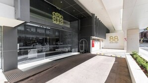 A modern building facade with a large glass window, a metal gate, and the number "88" indicating the address. - free parking lovely 2 bds  in heart of chatswood (Chatswood)