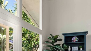A room with wicker chairs, a blue cabinet, and a large plant. - Classic Cottage in the Heart of La Jolla Shores (San Diego)