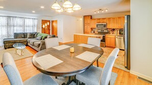 A modern living room with a dining table, seating, and a kitchen area with appliances. - 4 Mi to Dtwn: Pet-friendly Home in Utica (Utica)