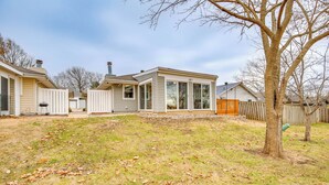 A residential property with a detached house featuring a large garage, a covered patio, and a fenced backyard. - 13 Mi to Arrowhead Stadium: Blue Springs Home! (Blue Springs)