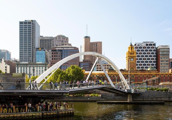 Stroll across the iconic pedestrian bridge, taking in the city's blend of historic and modern architecture.