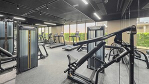 A gym with treadmills, weight machines, and exercise equipment.