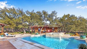 A swimming pool with a wooden deck, lounge chairs, and a gazebo. - Luxury Ranch w/ Pool, Hot Tub, Chef's Kitchen + Close to Wineries (Wimberley)
