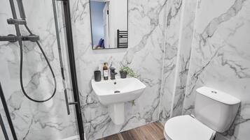 Shower, hair dryer, towels, shampoo