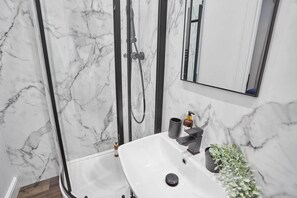 Shower, hair dryer, towels, shampoo