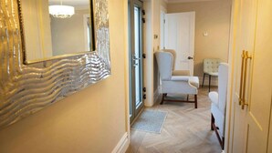 A hallway with a patterned mirror, a door, and two upholstered chairs. - Private Country Residence, Made 4 Luxury Gathering (Newcastle West)