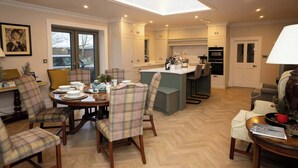 A modern kitchen with a skylight, a dining area with plaid chairs, and a cozy living space with a lamp. - Private Country Residence, Made 4 Luxury Gathering (Newcastle West)