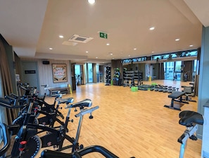 A gym with treadmills, weight machines, and free weights.