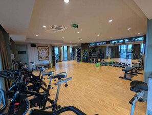 A gym with treadmills, weight machines, and free weights. - Suite Life: Top-Floor 2-Bed, 1-Bath in Ancoats (Greater Manchester)