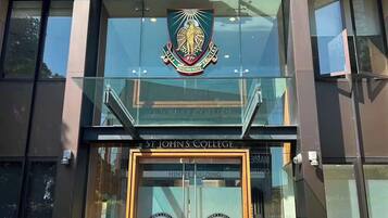 The entrance to St. John's College with a prominent crest above the doors.