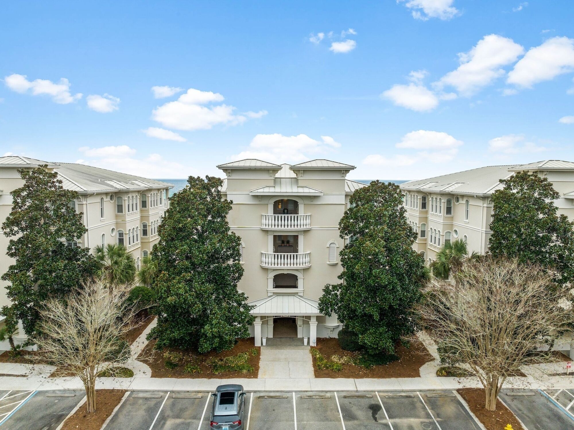 A multi-story building with a symmetrical facade, central entrance, and balconies.