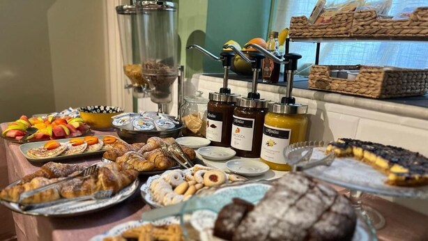 A buffet table with a variety of desserts, including pies, cakes, and pastries, along with condiments and spreads. - HOTEL BRENTA  (Parma)