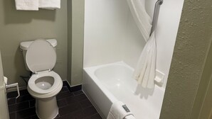 A bathroom with a toilet, a bathtub, and a shower curtain. - We in Heart DownTown of Columbus and Fort Moore (Columbus)