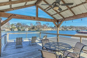 Relax on the deck with a view of the marina and water, surrounded by a swimming pool and dock.