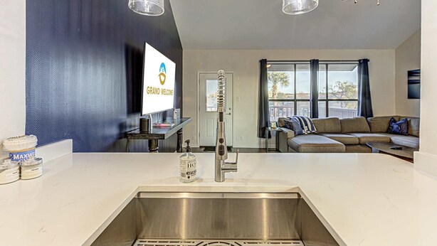 A modern kitchen with a stainless steel sink, a ceiling fan, and pendant lights. - Cozy 3 BDR Condo in Horseshoe Bay, Near Marina! (Horseshoe Bay)