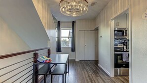 A modern kitchen with built-in appliances, a dining area with a bench, and a chandelier. - Cozy 3 BDR Condo in Horseshoe Bay, Near Marina! (Horseshoe Bay)